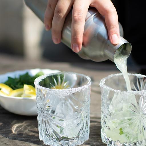 #719 person pouring water on drinking glasses