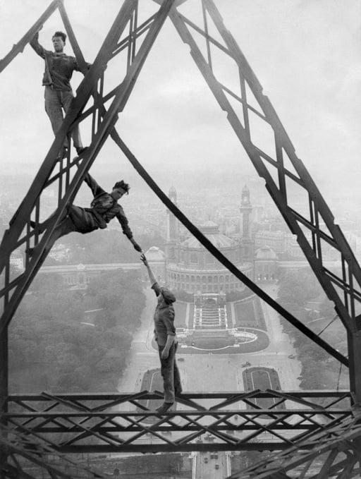 Acrobatic workers on the Eiffel Tower in front of the Trocadero Palace